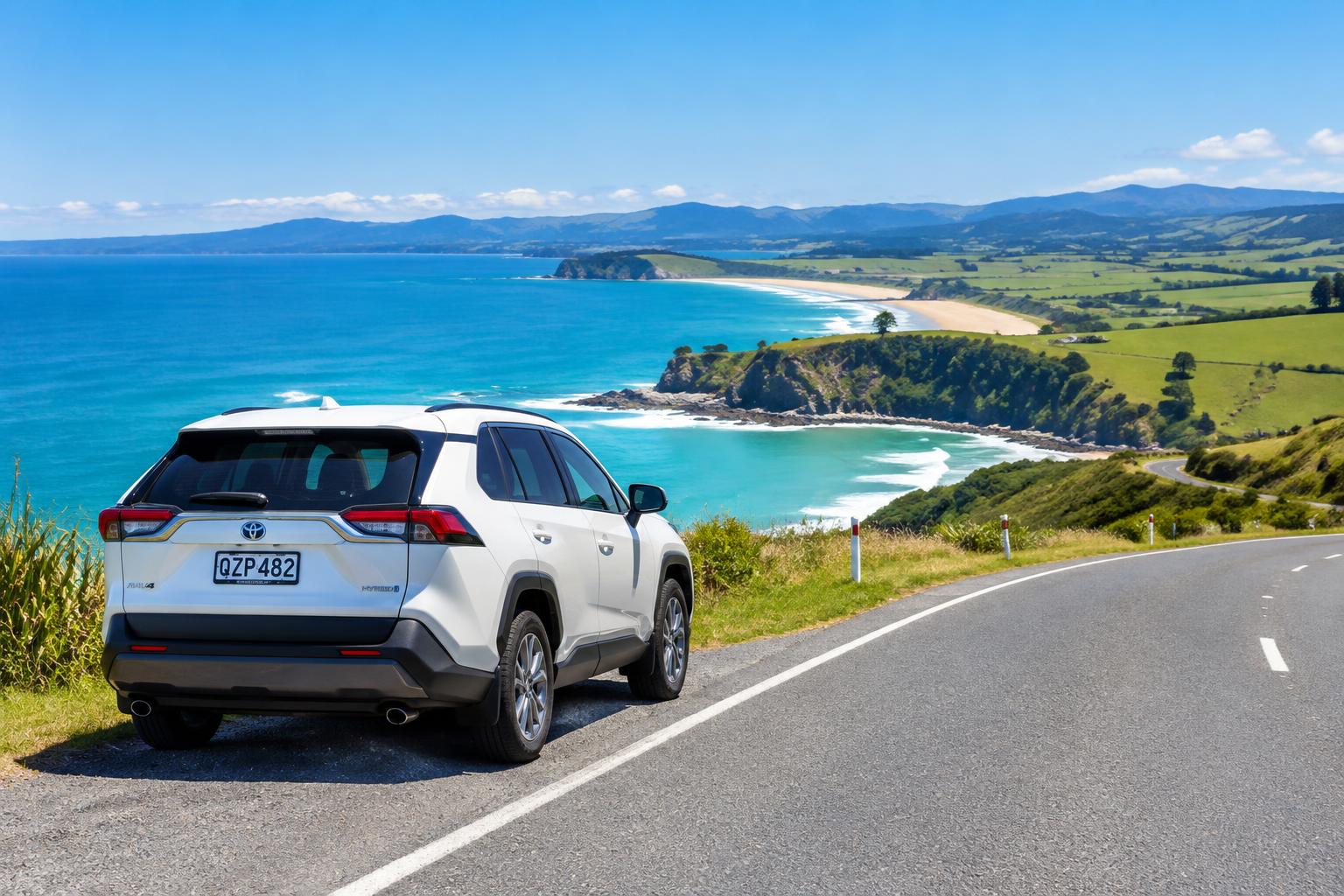 White SUV overlooking a turquoise bay